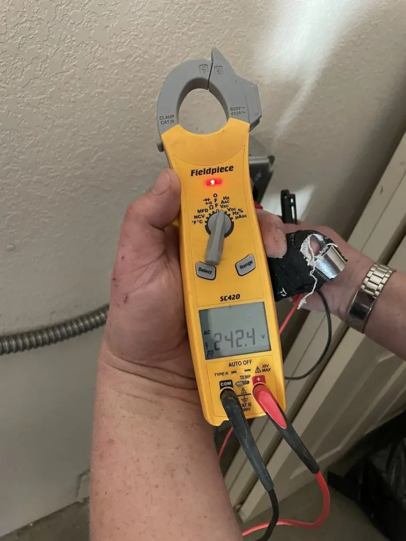 Voltage testing with clamp meter during Whole House Surge Protector in Oyster Bay